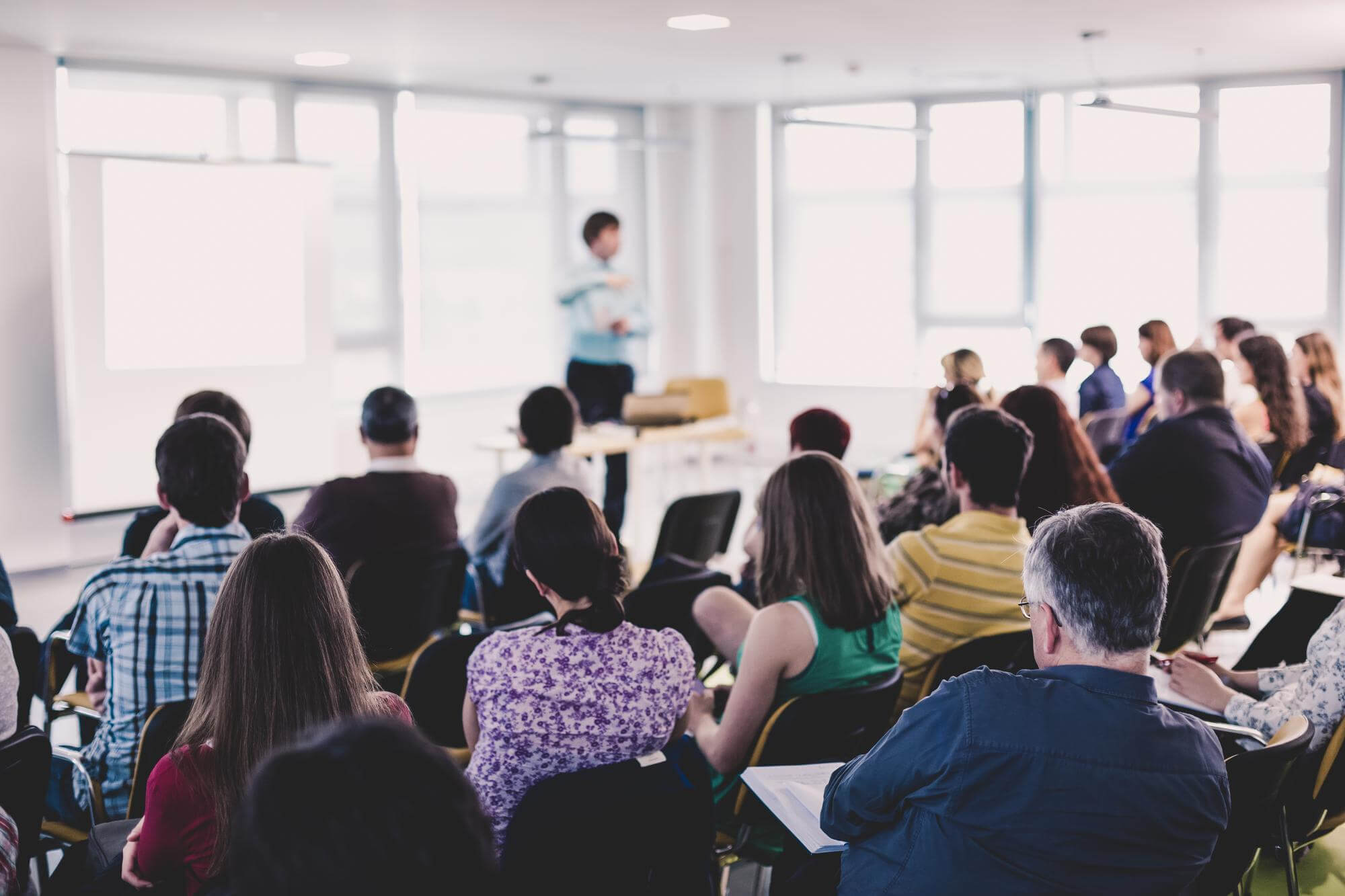 Speaker giving presentation on business conference Working on Tab